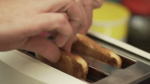 Slices of bread popping out of the toaster Stock Footage 104002809
