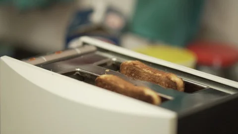 Slices of bread popping out of the toaster in slow motion Stock Footage 104004581