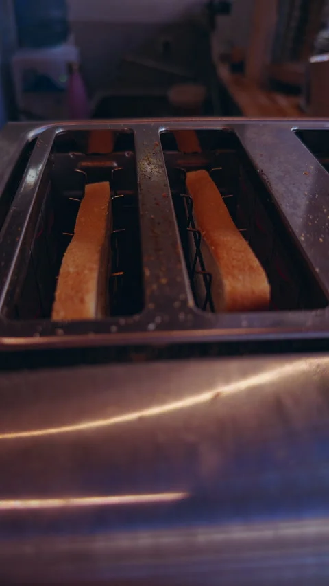 Slices Of Bread Toasting Inside Stainless Steel Toaster During Breakfast Prepara Stock Footage 336812236