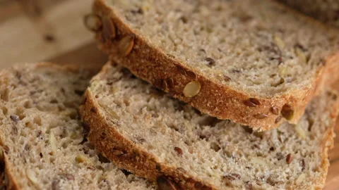 Slices bread from whole wheat flour, flax, sunflower and pumpkin seeds close-up Stock Footage 131294054