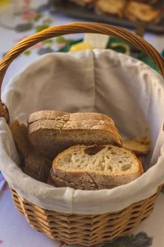 Slices of bread in a wicker basket Stock Photos