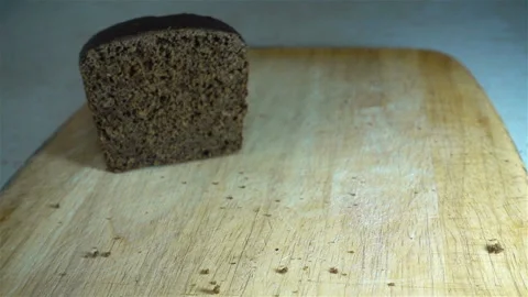 Slices of brown bread fall in slow motion Stock Footage 133346650