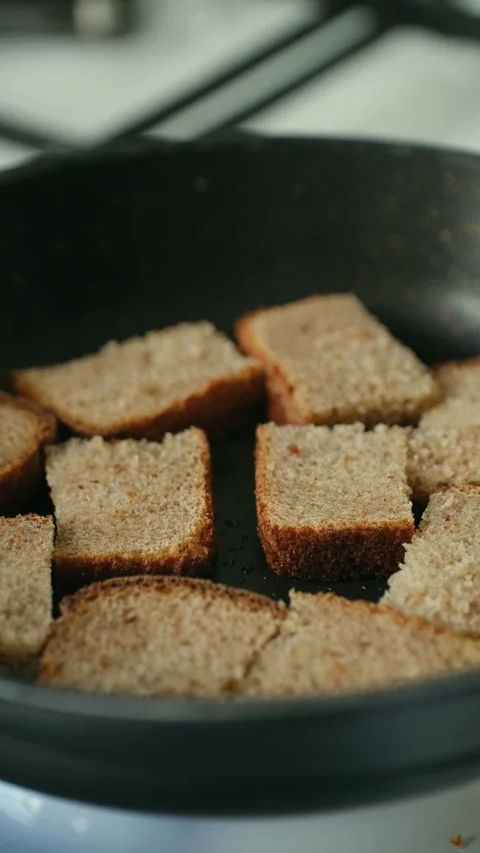 Slices of brown bread toasting in a pan Stock Footage 337830473
