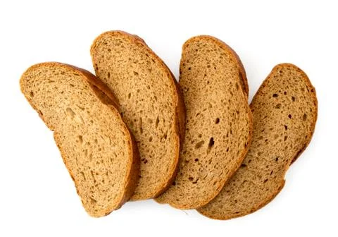 Slices of brown bread on a white. The view of the top. Stock Photos