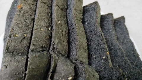 Slices of charcoal bread Stock Footage 261154782