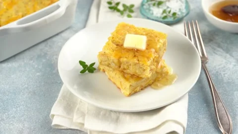 Slices of cheesy cornbread freshly baked served with butter and honey Stock Footage 242525666