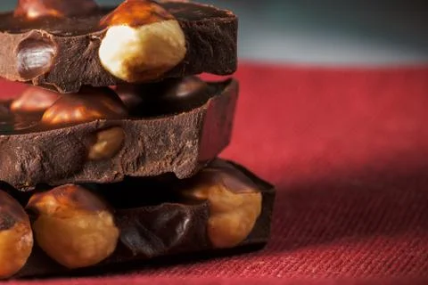Slices of chocolate with hazelnuts Stock Photos
