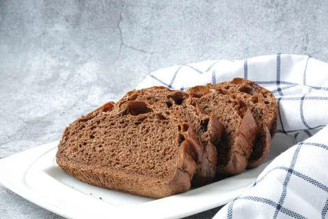 Slices of chocolate soft bread in white plate Stock Photos