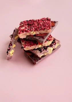 Slices of chokolate bars with nuts and berries with space for text Stock Photos