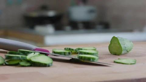 Slices Cucumber And Knife On The Table In Kitchen Video stock 157994369