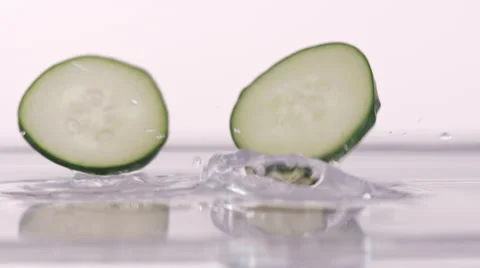 Slices Of Cucumber Dropping Into Water Stock Footage 52959910