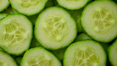 Slices of cucumber spin closeup Stock Footage 121522089