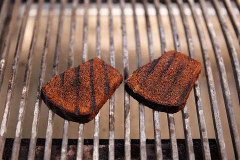 Slices of dark bread on a grill Stock Photos