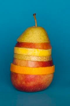 Slices of different fruit stacked to comprise the shape of a piece of fruit Stock Photos