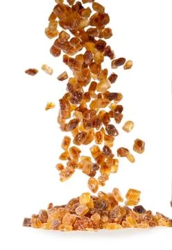 Slices of falling brown candy sugar Foto stock