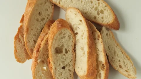 Slices of fresh bread appearing on white background Stock Footage 335435393