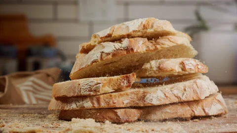 Slices of fresh bred falling in slow motion on the table Stock Footage 153465596