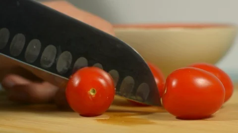 Slices fresh cherry tomatoes on the kitchen table Stock-Footage 128917765