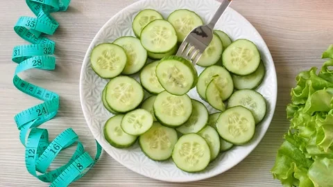 Slices of fresh cucumber on a plate put it on the table. The concept of healthy  Video stock 237859157