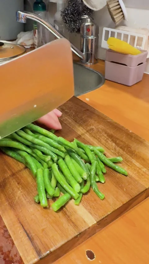 Slices of fresh garlic scapes mixed with thick brown sesame paste Stock Footage 333858985