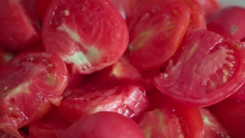 Slices of fresh tomatoes close-up in slow motion camera. Stock Footage 248296310