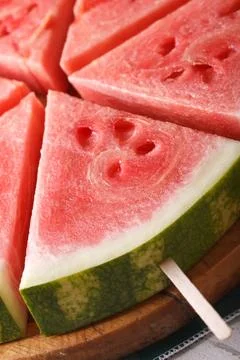 Slices of fresh watermelon on a stick macro. vertical Stock Photos
