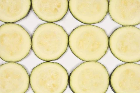 Slices of Green Zucchini in Grid Pattern on White Stock Photos
