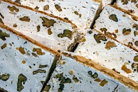 Slices of halva with nuts Stock Photos