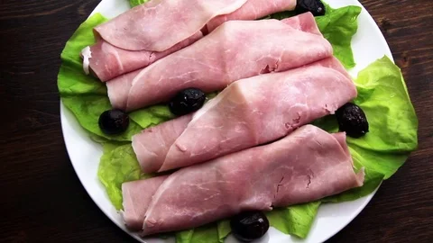 Slices of ham on plate Stock Footage 86523789
