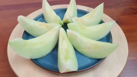 Slices of honeydew melon without seeds on top of spinning turntable. Stock Footage 159830587