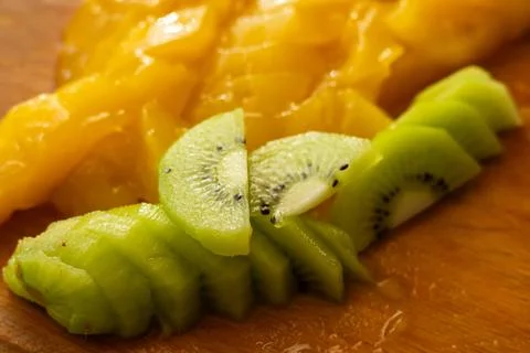 Slices of kiwi and slice mango on the desk Stock Photos