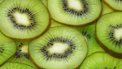 Slices of Kiwi Fruit Rotating on Turntable Stock Footage 93607199