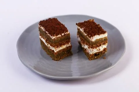 Slices of layered cake featuring alternating dark spiced cake layers Stock Photos