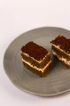 Slices of layered cake featuring alternating dark spiced cake layers Stock Photos