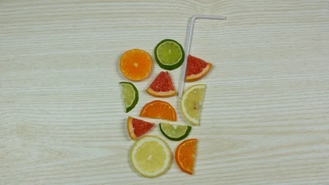 Slices of lemon, orange, lime fall forming glass. Preparation of citrus drink Video stock 121378880