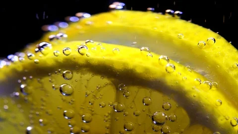 Slices of a lemon into the water Stock Footage 100034970