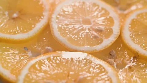 Slices of lemons are displayed closely, showing their vibrant color and texture. Vidéo 338297841