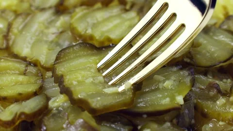 Slices of marinated cucumber salad taking by a fork close up Stock Footage 277684745