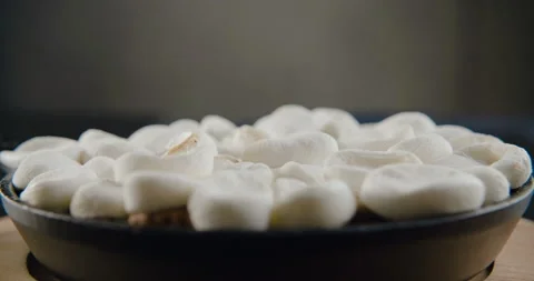 Slices of marshmallows are set on fire in slow motion Stock Footage 101370233