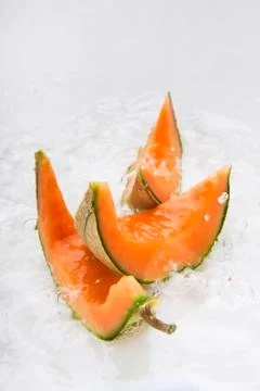 Slices of melon in water Stock Photos