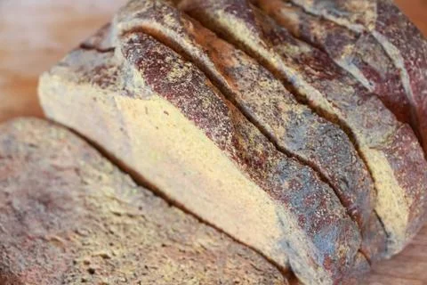 Slices of old moldy rye bread on wooden shelf Stock Photos