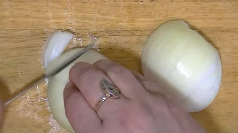 Slices of onion by hand using a sharp knife Stock Footage 62477272