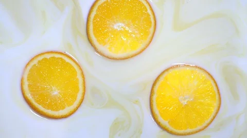 Slices of orange in milk Video stock 123874860