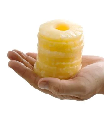 Slices of pineapple in the palm Foto stock