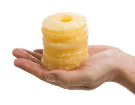 Slices of pineapple in the palm Foto stock