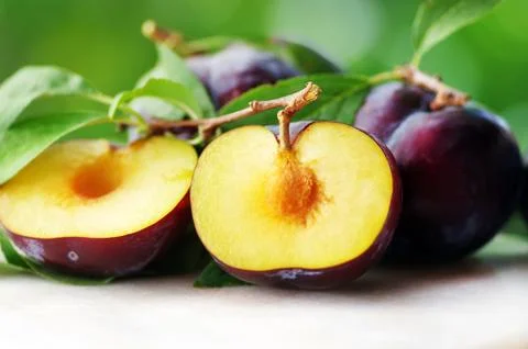 Slices of Plums on table Stock Photos