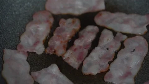 Slices of pork bacon is prepared in its own fat. Layers of meat and lard. 스톡 동영상 334642315
