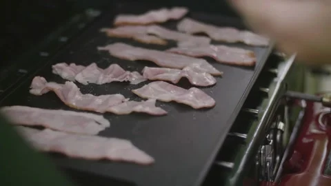 Slices of pork bacon is prepared in its own fat. Layers of meat and lard. 스톡 동영상 334642361
