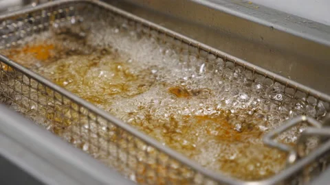 Slices of potatoes rustic is frying in hot boiling oil at cuisine. Crispy french Stock Footage 146581278