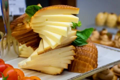 Slices of processed cheese with tomatoes on a tray - Close-up Stock Photos